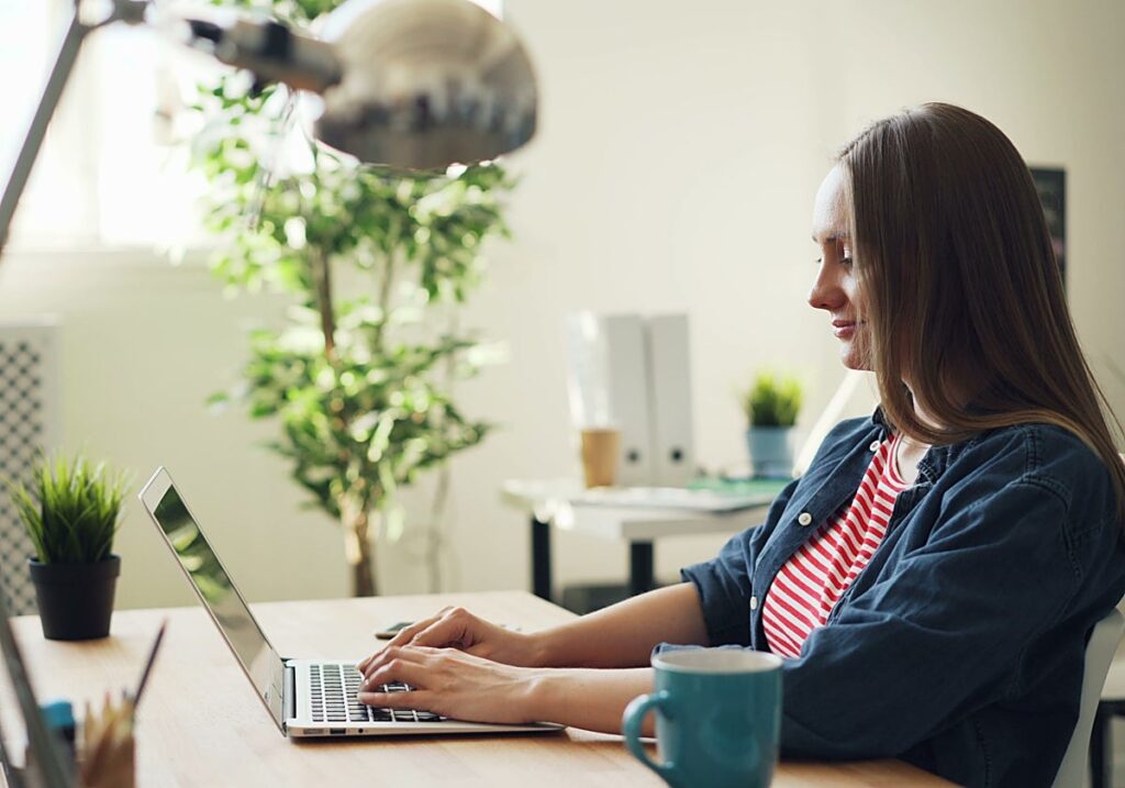 Mujer trabajando en una computadora portátil en un entorno moderno